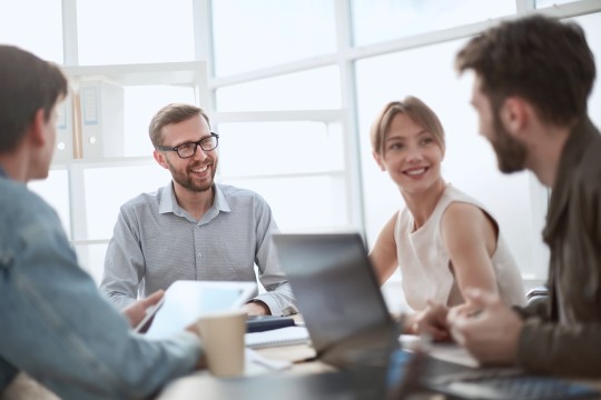 four persons in a team meeting