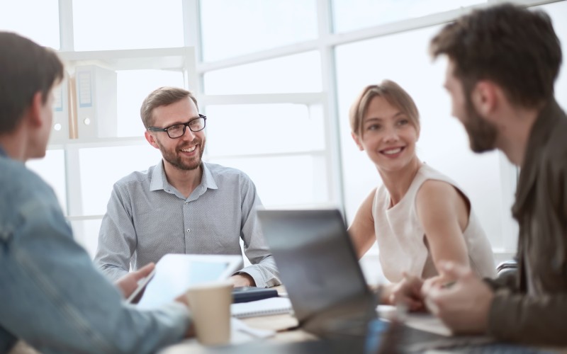 four persons in a team meeting