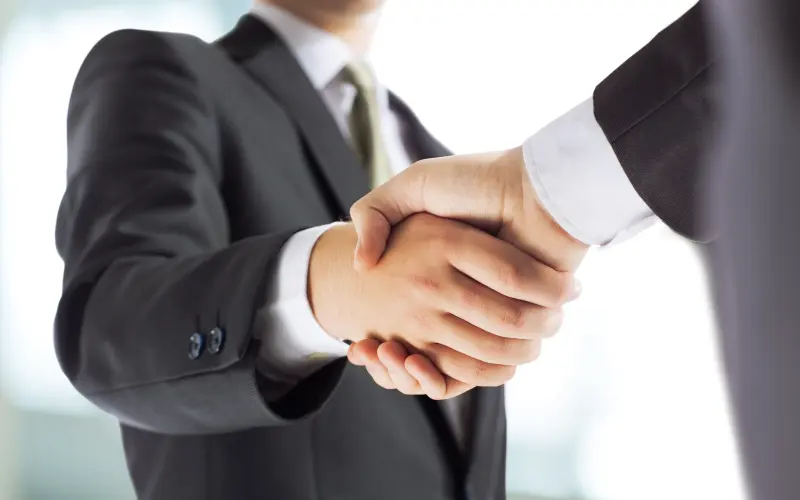 Handshake of two people with suits