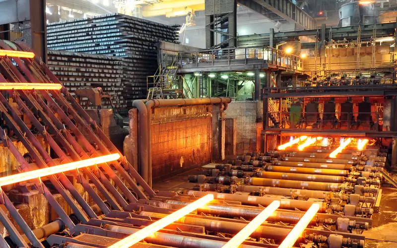Steel plant from inside, hot steel on conveyor belt