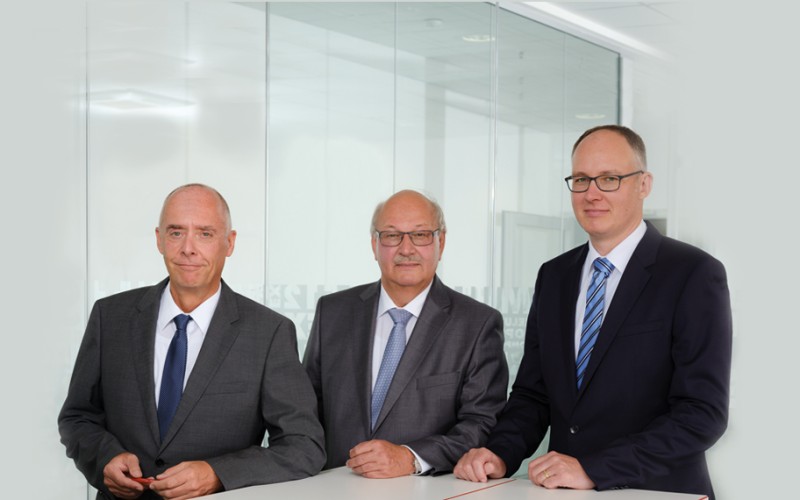 The three Managing Directors in suits of Helukabel GmbH 