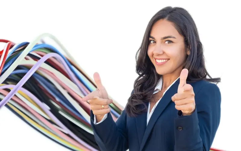 A young woman smiling and showing thumbs up