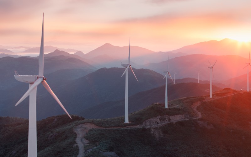 Wind turbines at sunset on a mountain