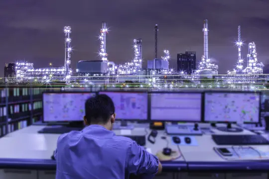 control room with raffinery in the background