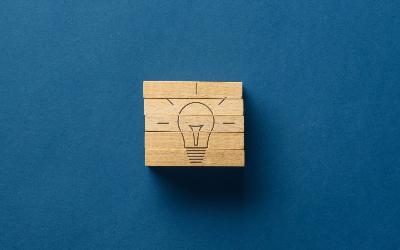 Wooden cube with light bulb on it