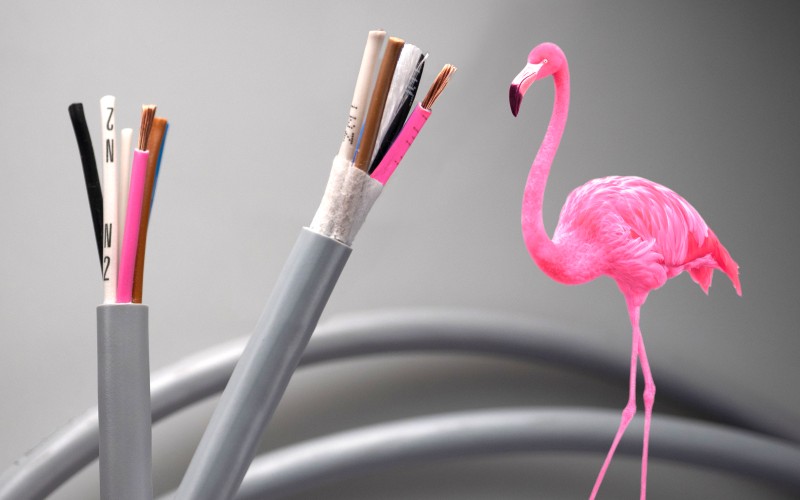 Cable with pink wire next to a pink flamingo
