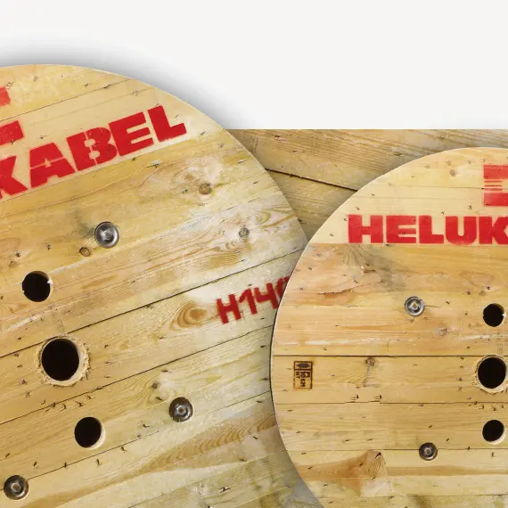 A close-up of two cable drums printed with the iconic red HELUKABEL logo.