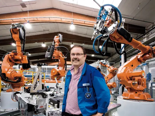 Manfred Scheuerer in front of the robots