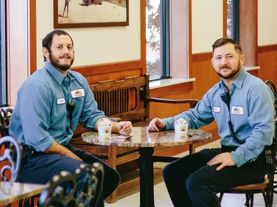 Engineering technicians sit at a table eating ice cream