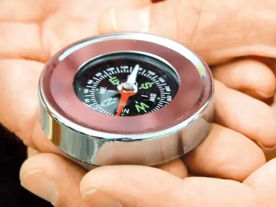 A compass in someones hand